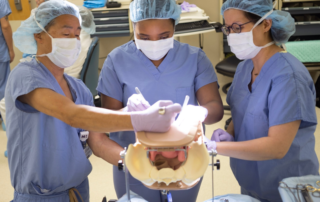 OBGYN professionals practicing a procedure on the Miya Model pelvic simulator