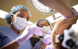 Student Participating in Surgical Training With Instructor